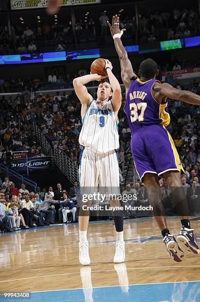 Darius Songaila of the New Orleans Hornets takes a shot against Ron Artest of the Los Angeles Lakers on March 29, 2010 at the New Orleans Arena in...