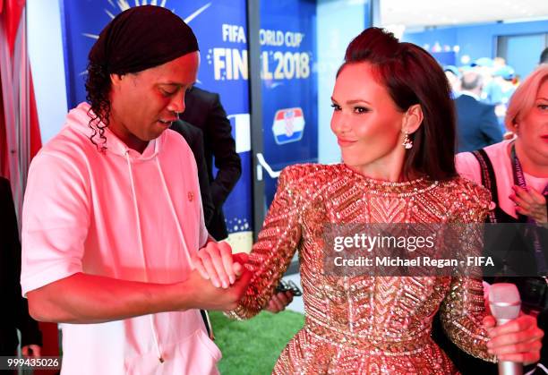 Ronaldinho shakes hands with Opera singer Aida Garifullina in the tunnel prior to the 2018 FIFA World Cup Final between France and Croatia at...