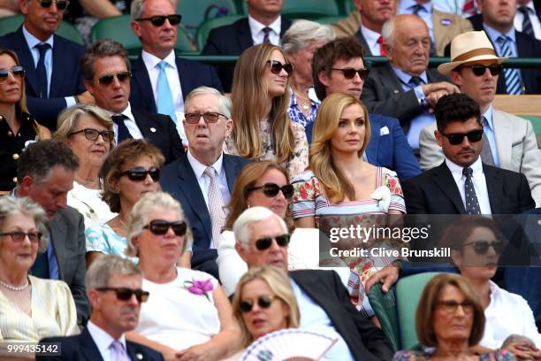 Anna Eberstein, Hugh Grant, Hannah Bagshawe, Eddie Redmayne and Benedict Cumberbatch sit behind Katherine Jenkins and Andrew Levitas as they attend...