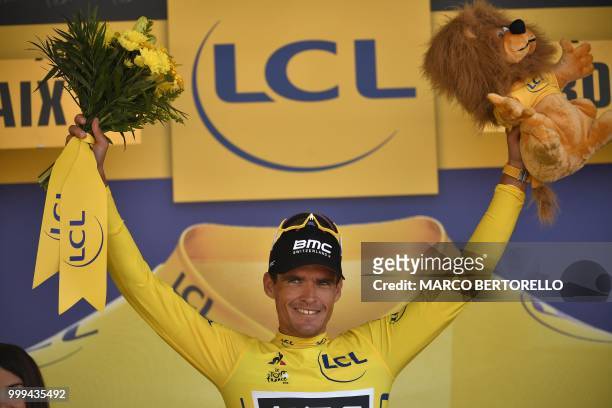 Belgium's Greg Van Avermaet, wearing the overall leader's yellow jersey, celebrates on the podium after the ninth stage of the 105th edition of the...