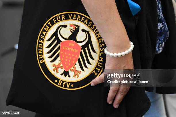 Visitor carries a bag with the logo of the constitutional protection office at the Ministry of Interior Affairs in Berlin, Germany, 26 August 2017....