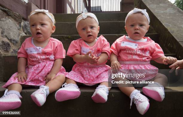 Dpatop - The triplets Lisa , Nelly and Emilia from Hochheim pose for a photo at the traditional triplet meeting of the Hessian Prime Minister at the...