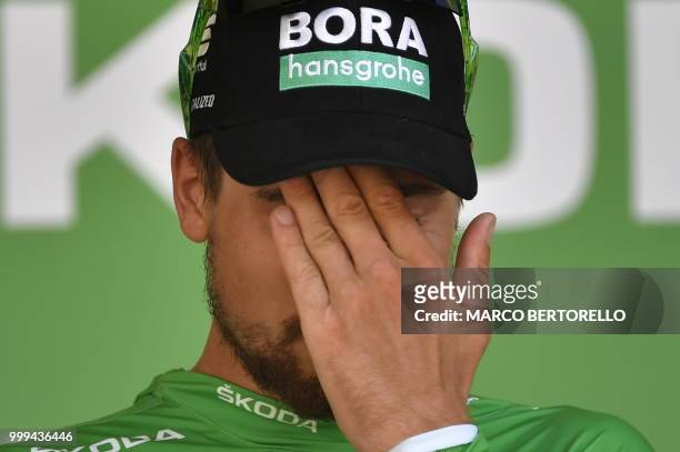 Slovakia's Peter Sagan, wearing the best sprinter's green jersey, reacts on the podium after the ninth stage of the 105th edition of the Tour de...