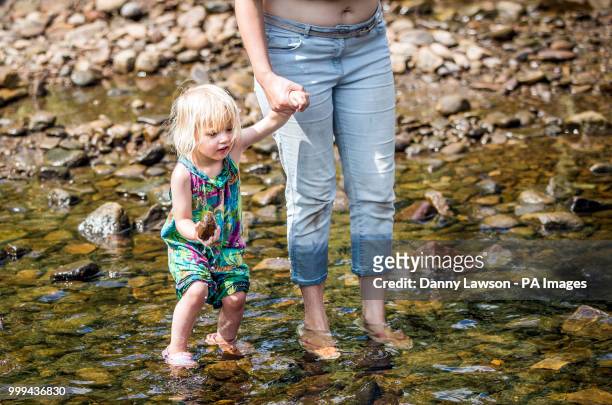 Maisie Marsh paddling in Hebden Beck at Hebden Bridge, West Yorkshire, as hot weather continues across the UK.