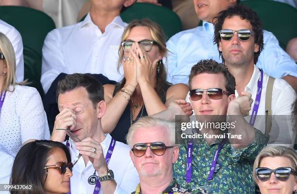 Kate Winslet reacts as Ned Rocknroll looks on during the men's singles final on day thirteen of the Wimbledon Tennis Championships at the All England...