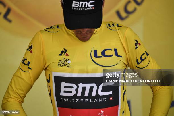 Belgium's Greg Van Avermaet puts on the overall leader's yellow jersey on the podium after the ninth stage of the 105th edition of the Tour de France...
