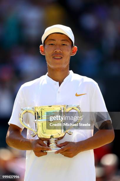 Chun Hsin Tseng of Taiwan celebrates with the trophy after defeating Jack Draper of Great Britain to win the Boys' Singles final on day thirteen of...