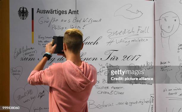 Visitor takes a photo of a giant guest book at the Ministry of Exterior Affairs in Berlin, Germany, 26 August 2017. The federal chancellery, the...