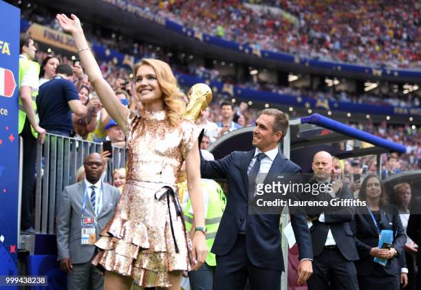 Russian model Natalia Vodianova and Former football player Philippe Lahm cheer fans during closing ceremony prior to the 2018 FIFA World Cup Final...