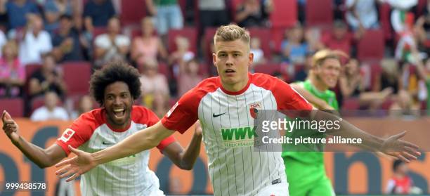 Augsburg's Alfred Finnbogason and Caiuby celebrate the 1:0 goal during the Bundesliga soccer match between FC Augsburg and Borussia Moenchengladbach...