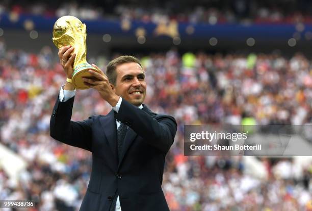 Former football player Philippe Lahm holds the World Cup trophy during closing ceremony prior to the 2018 FIFA World Cup Final between France and...