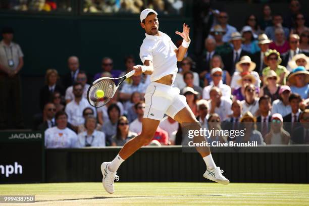 Novak Djokovic of Serbia returns against Kevin Anderson of South Africa during the Men's Singles final on day thirteen of the Wimbledon Lawn Tennis...