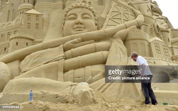 Artists work on the biggest sandcastle in the world at the landscape park in Duisburg, Germany, 26 August 2017. The artists want to enter the...