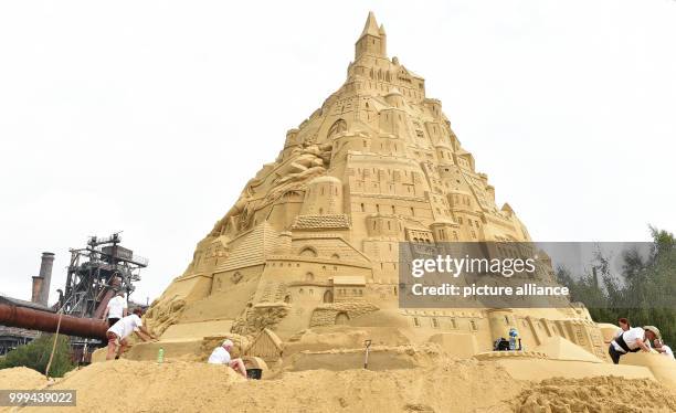 Artists work on the biggest sandcastle in the world at the landscape park in Duisburg, Germany, 26 August 2017. The artists want to enter the...