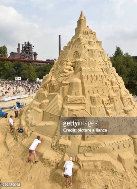 Artists work on the biggest sandcastle in the world at the landscape park in Duisburg, Germany, 26 August 2017. The artists want to enter the...