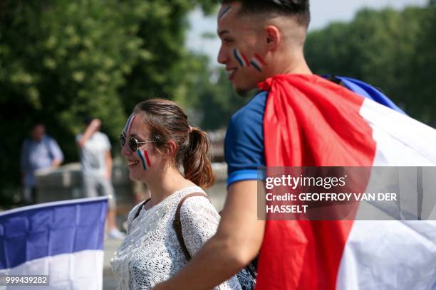 France supporters hold French flags as they gather to watch the Russia 2018 World Cup final football match between France and Croatia, in Paris on...