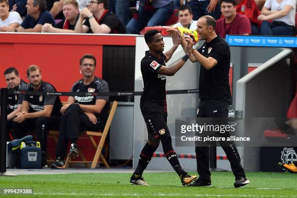 Leverkusen's Wendell is congratulated by his head coach Heiko Herrlich over his 1-0 score during the Bundesliga soccer match between Bayer Leverkusen...
