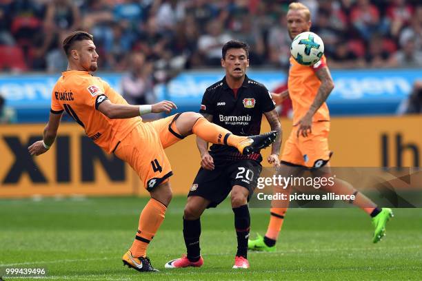 Leverkusen's Charles Aranguiz and Hoffenheim's Ermin Bicakcic in action during the Bundesliga soccer match between Bayer Leverkusen and 1899...