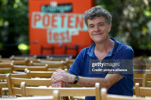 Dpatop - Author Renus Berbig sits in front of a podium in the castle garden at the Erlangen Poets Festival in Erlangen, Germany, 26 August 2017....