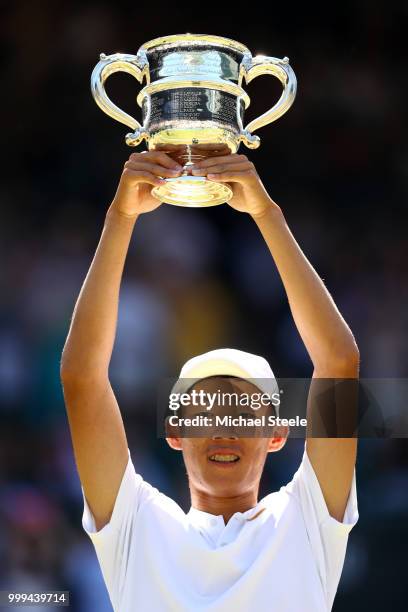 Chun Hsin Tseng of Taiwan celebrates with the trophy after defeating Jack Draper of Great Britain to win the Boys' Singles final on day thirteen of...