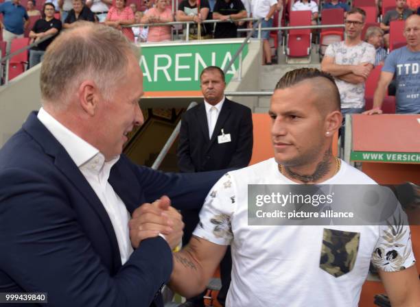 Augsburg's sports director Stefan Reuter welcomes Gladbach's Raul Bobadilla before the Bundesliga soccer match between FC Augsburg and Borussia...