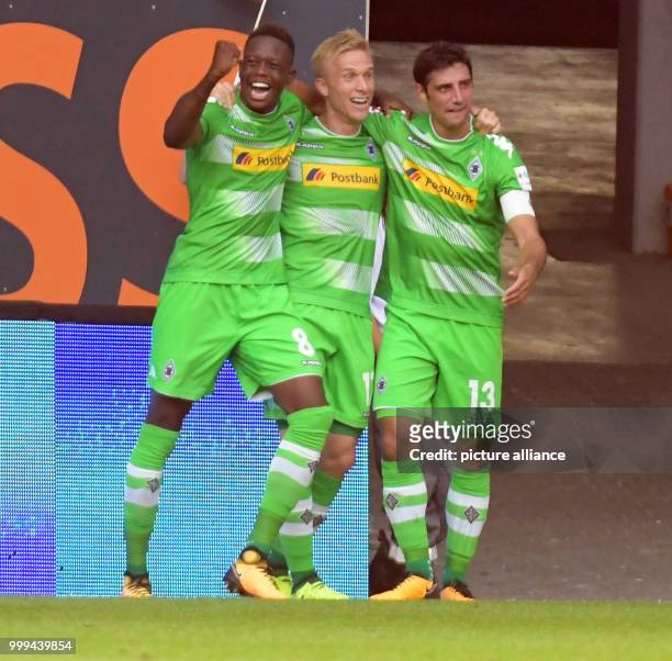 Gladbach's Denis Zakaria, Oscar Wendt and Lars Stindl celebrate the 1:2 goal during the Bundesliga soccer match between FC Augsburg and Borussia...