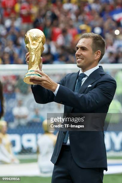 Former football player Philippe Lahm holds the World Cup trophy during closing ceremony prior to the 2018 FIFA World Cup Final between France and...