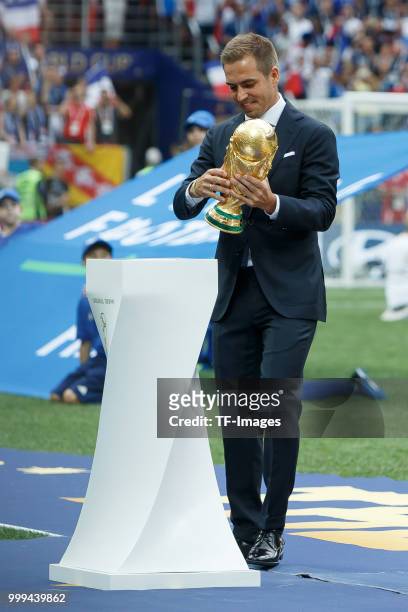 Former football player Philippe Lahm holds the World Cup trophy during closing ceremony prior to the 2018 FIFA World Cup Final between France and...