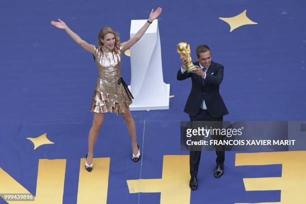 Former German captain Philipp Lahm and Russian model Natalia Vodianova bring out the trophy ahead of the Russia 2018 World Cup final football match...