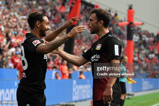 Leverkusen's goalkeeper Karim Bellarabi and Admir Mehmedi cheer over the 2-1 score during the Bundesliga soccer match between Bayer Leverkusen and...