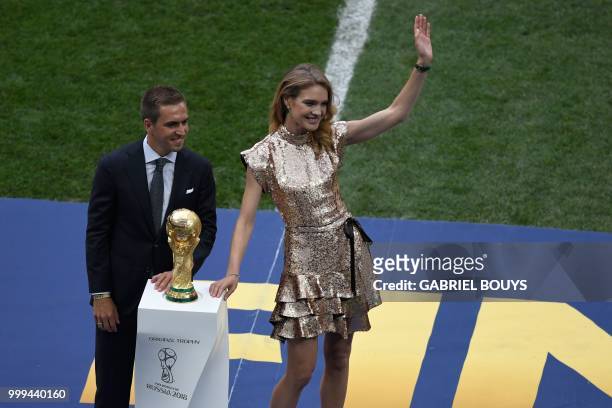 Germany's former captain Philipp Lahm and Russian model Natalia Vodianova pose next to the trophy during the closing ceremony prior to the Russia...