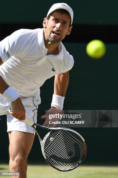 Serbia's Novak Djokovic serves to South Africa's Kevin Anderson in their men's singles final match on the thirteenth day of the 2018 Wimbledon...