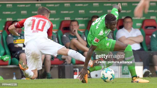 Augsburg's Daniel Baier and Gladbach's Denis Zakaria in action during the Bundesliga soccer match between FC Augsburg and Borussia Moenchengladbach...