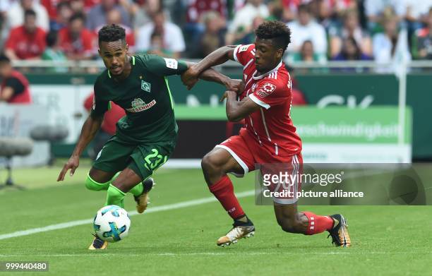 Munich's Kingsley Coman and Bremen's Theodor Gebre Selassie vie for the ball during the Bundesliga soccer match between Werder Bremen and Bayern...