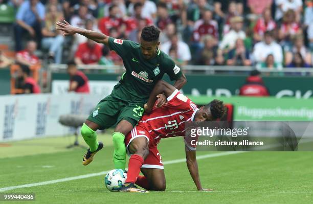Munich's Kingsley Coman and Bremen's Theodor Gebre Selassie vie for the ball during the Bundesliga soccer match between Werder Bremen and Bayern...