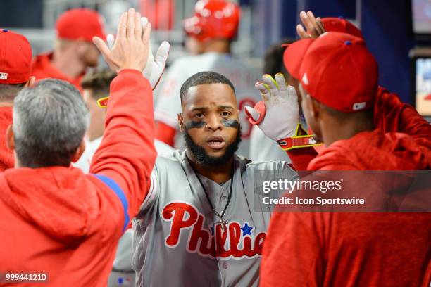 Phillies first baseman Carlos Santana is congratulated by teammates after hitting a home run during the game between the Braves and the Phillies on...