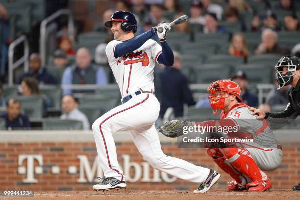 Braves catcher Chris Stewart outfielder Nick Markakis watches his deep drive to the outfield during a game between the Braves and the Phillies on...