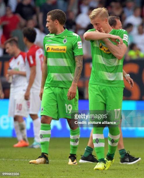 Gladbach's Fabian Johnson and Oscar Wendt react after the Bundesliga soccer match between FC Augsburg and Borussia Moenchengladbach at the WWK Arena...