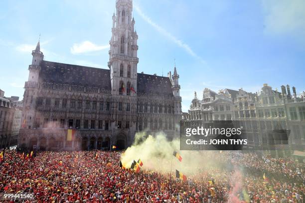 Belgium's supporters cheer and wave flags as they celabrate the arrival of Red Devil football players at the Grand Place/Grote Markt in Brussels city...