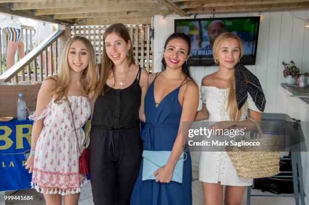 Evan Silvera, Ellie Rakower, Erica Commisso and Polina Meshkova attend the Modern Luxury + The Next Wave at Breakers Montauk on July 14, 2018 in...