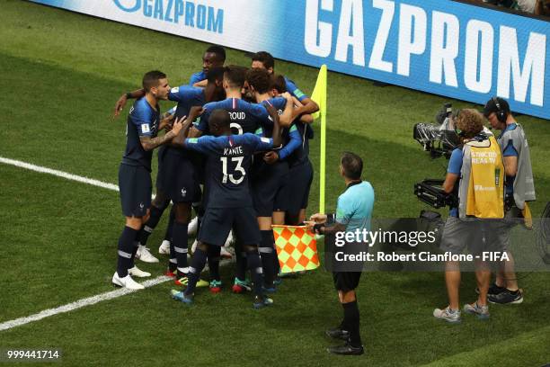 Antoine Griezmann of France celebrates with teammates after his free-kick leads to an own goal by Mario Mandzukic of Croatia, and France's first goal...