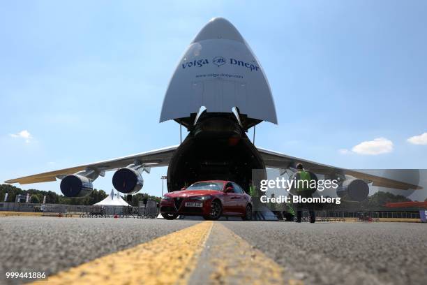 An Alfa-Romeo automobile is unloaded from a Volga-Dnepr Group air cargo aircraft during preparations ahead of the Farnborough International Airshow...