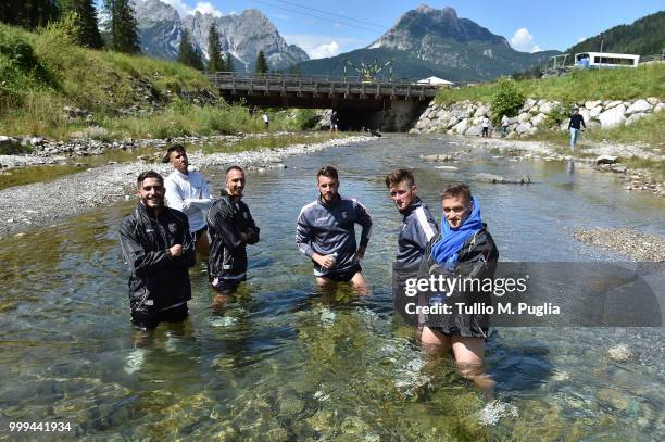 Fabrizio Alastra, Luca Fiordilino, Antonino Mazzotta, Premizlaw Sziminski, Corentin Fior and Radoslaw Muraski pose for photos in a river after a...