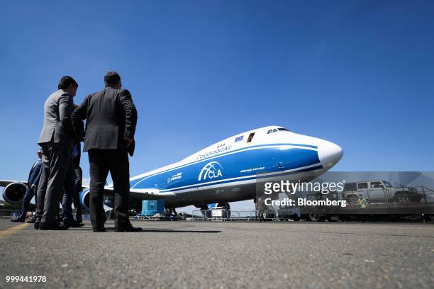 Attendees watch a demonstration of a jeep being loaded onto a Boeing Co. 747 cargo aircraft operated by CargoLogicAir Ltd. During preparations ahead...