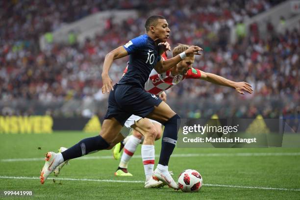 Kylian Mbappe of France and Ivan Strinic of Croatia battle for possession during the 2018 FIFA World Cup Final between France and Croatia at Luzhniki...