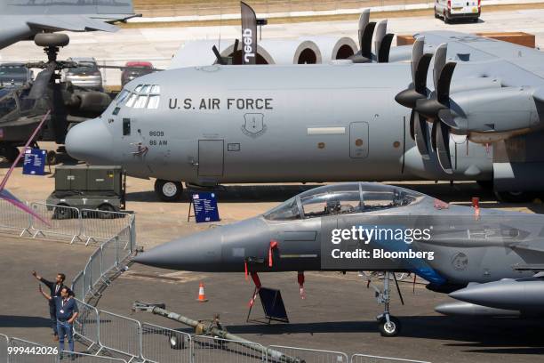 Attendees take selfie photographs with an F-15E Strike Eagle fighter jet, produced by Boeing Co., during preparations ahead of the Farnborough...