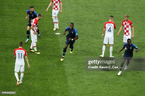 Paul Pogba and Blaise Matuidi of France celebrate after Mario Mandzukic of Croatia scores an own goal for France's first goal during the 2018 FIFA...