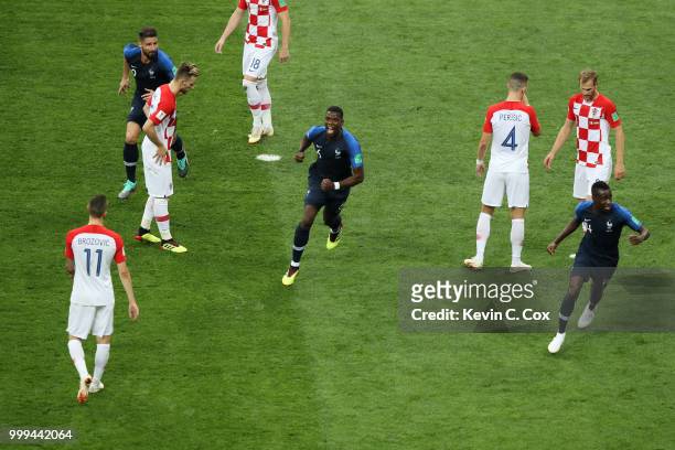 Paul Pogba and Blaise Matuidi of France celebrate after Mario Mandzukic of Croatia scores an own goal for France's first goal during the 2018 FIFA...