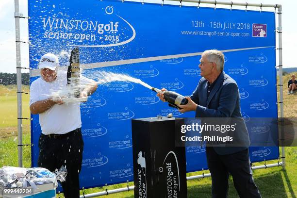 Mr Pon, owner WINSTONgolf sprays champagne on Stephen Dodd of Wales during the prizegiving after the final round on Day Three of the WINSTONgolf...