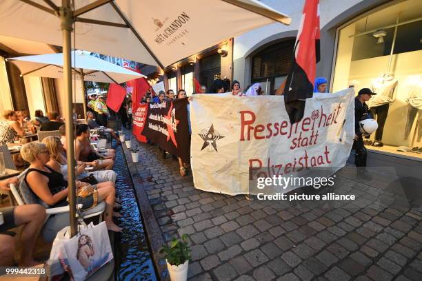 People partake in a demonstration of the leftist scene after the ban of the internet site "linksunten.indymedia.org" on the Augustiner Plaza in...